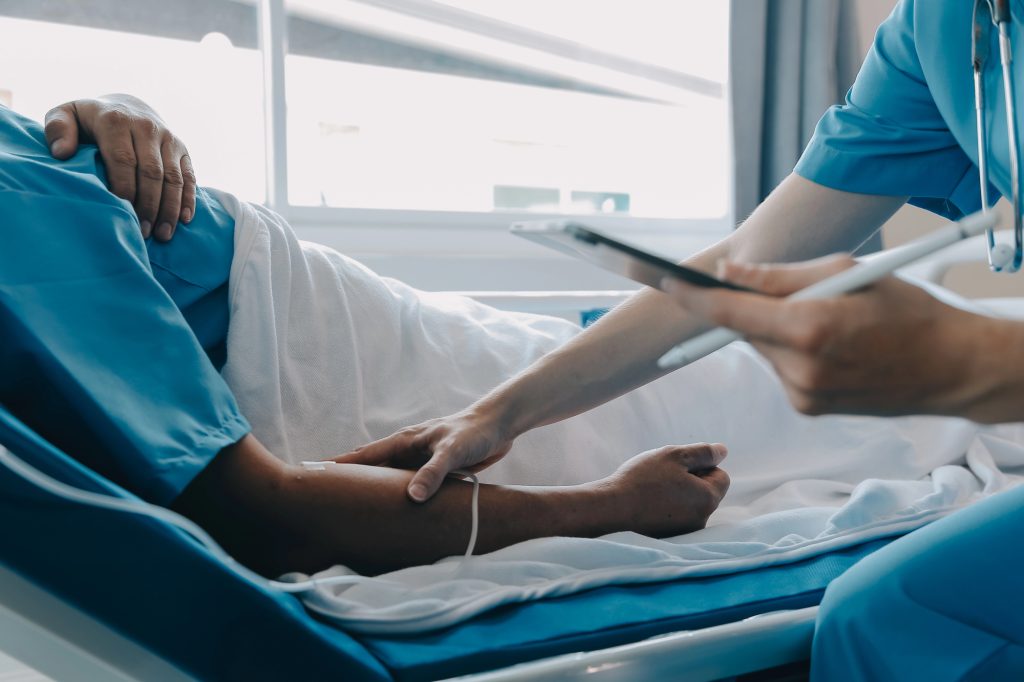 Patient after congenital penile curvature surgery in recovery room next to doctor